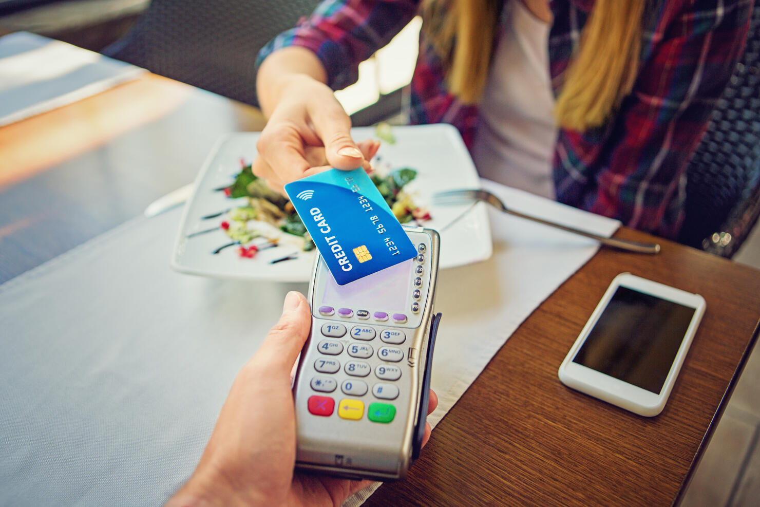 Young girl is paying using her credit card