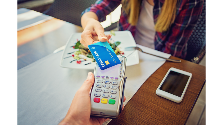 Young girl is paying using her credit card