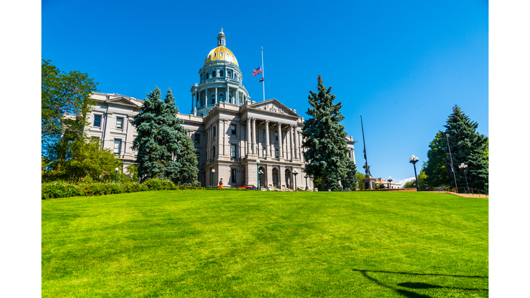 Colorado State Capitol building standing tall on green grass hill top