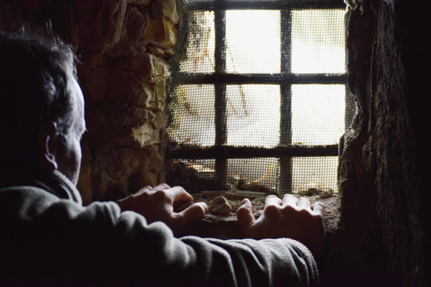 Man prisoner in the dark underground cell