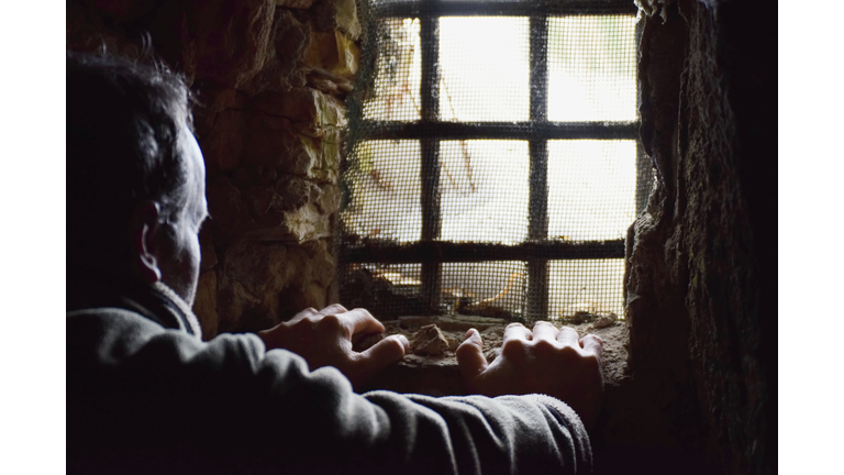 Man prisoner in the dark underground cell