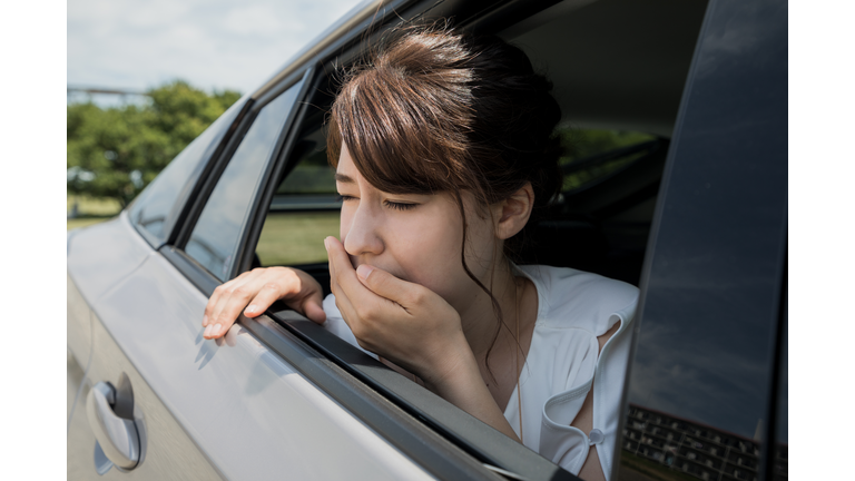 young woman getting carsickness.
