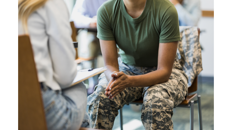 Close up photo female soldier leaning forward in seat