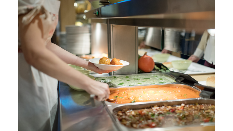 Cafeteria worker serving lunch