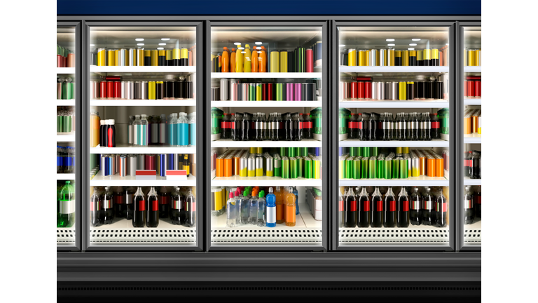 Juice cans and bottles in fridge at supermarket