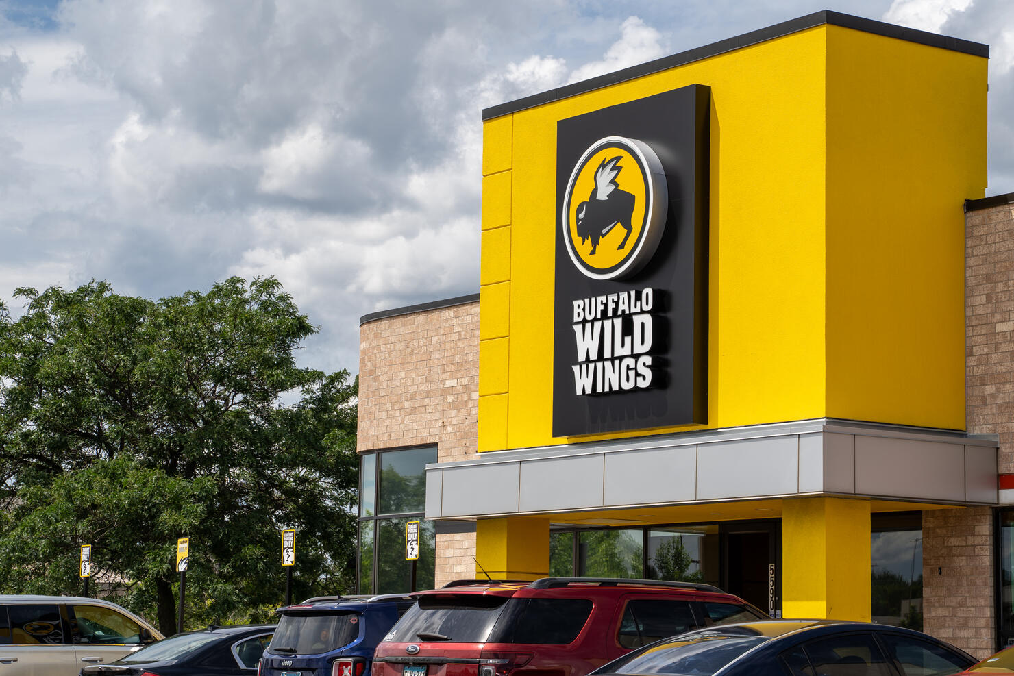 Exterior of a Buffalo Wild Wings chain restaurant. Also known as B-Dubs, this dine-in establishment sells chicken wings and pub food