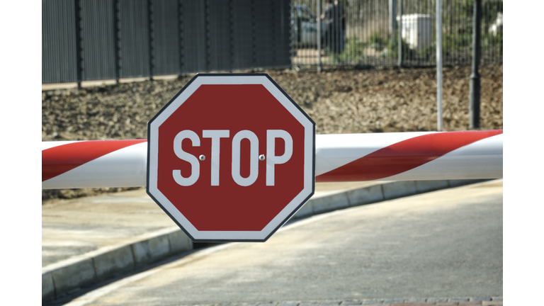 Security entry with big red Stop sign on the beam