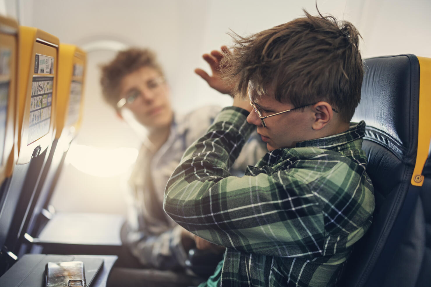 Naughty teenage kids travelling by plane