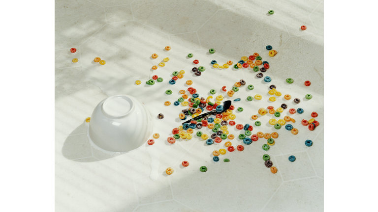 Spilt bowl of cereal on white floor