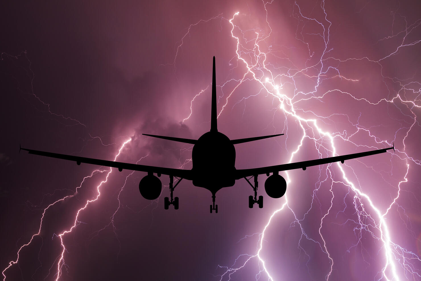 Airplane on the background of a thundercloud with lightning