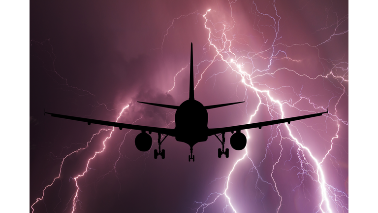 Airplane on the background of a thundercloud with lightning