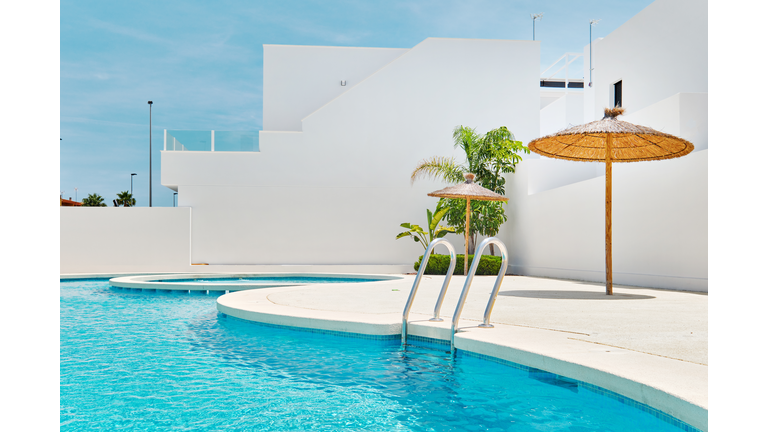 Empty poolside view at sunny summer day