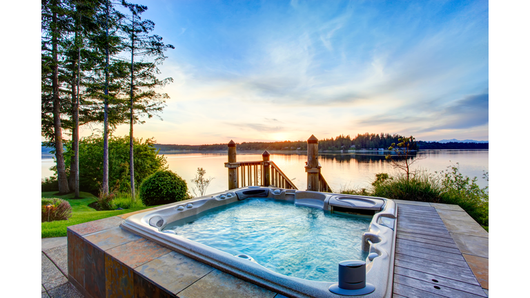 Awesome water view with hot tub in summer evening.