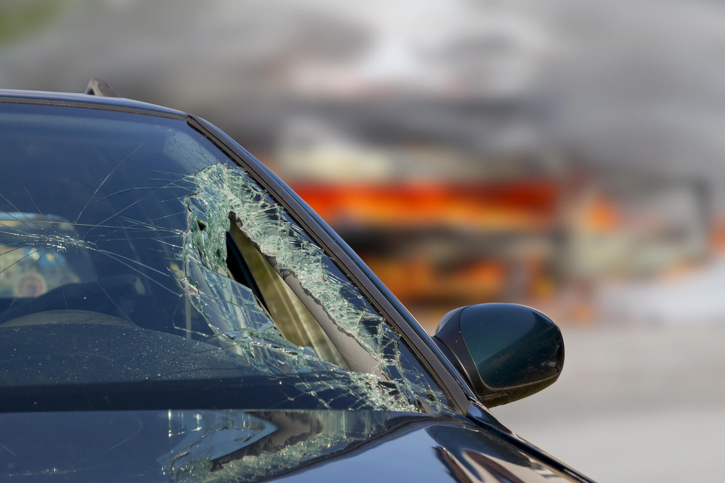 Broken windscreen at black car in traffic accident