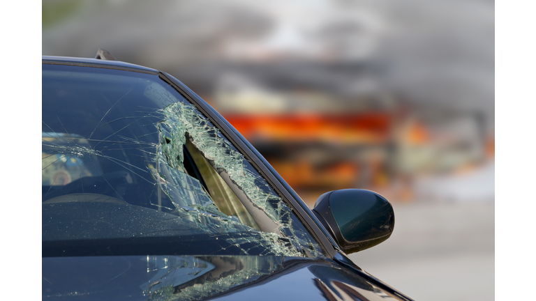 Broken windscreen at black car in traffic accident