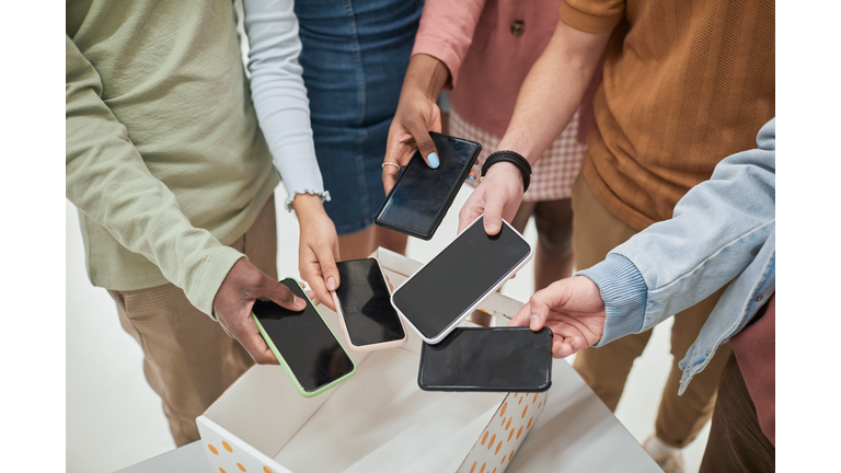 Students putting phones in box closeup