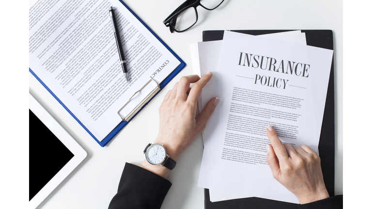 Business woman examining insurance policy