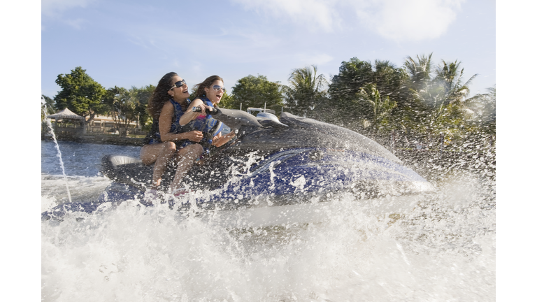 Friends riding a jet ski