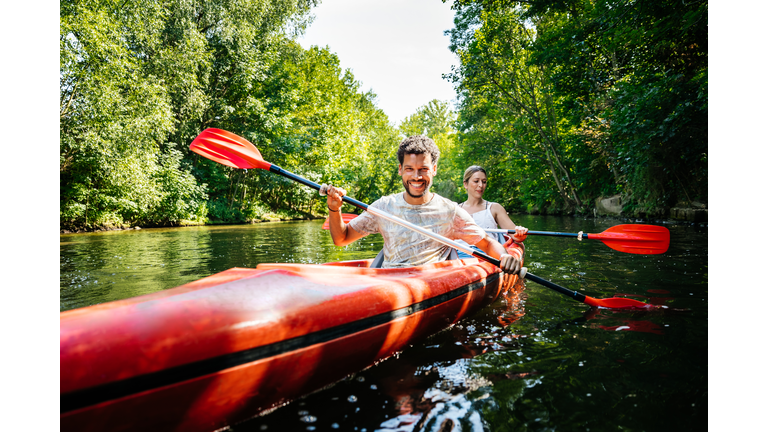 Couple Paddling Together In Kayak