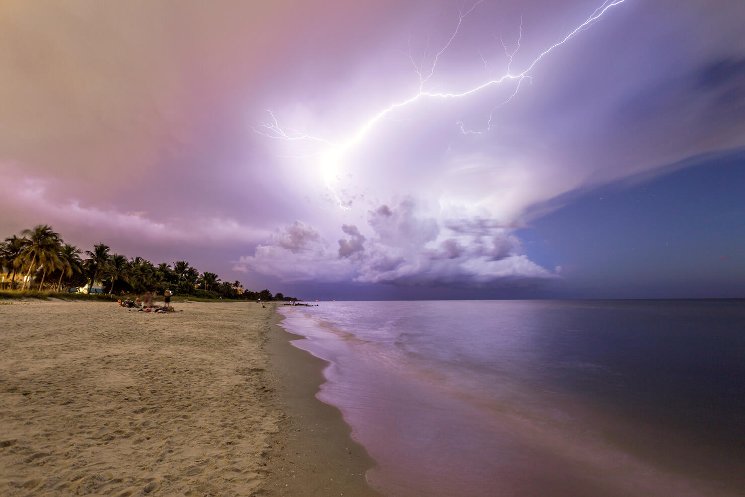 Amazing lightning storm sunset and calmed ocean, at Naples beach, Florida, USA
