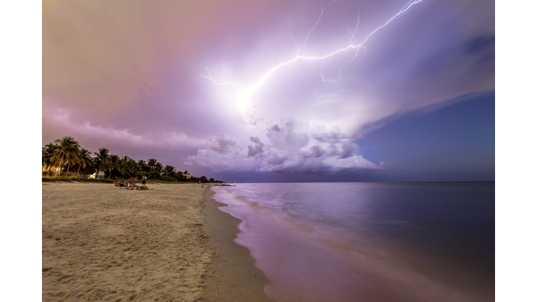 Amazing lightning storm sunset and calmed ocean, at Naples beach, Florida, USA