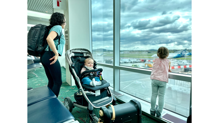 Happy baby at the airport with his family