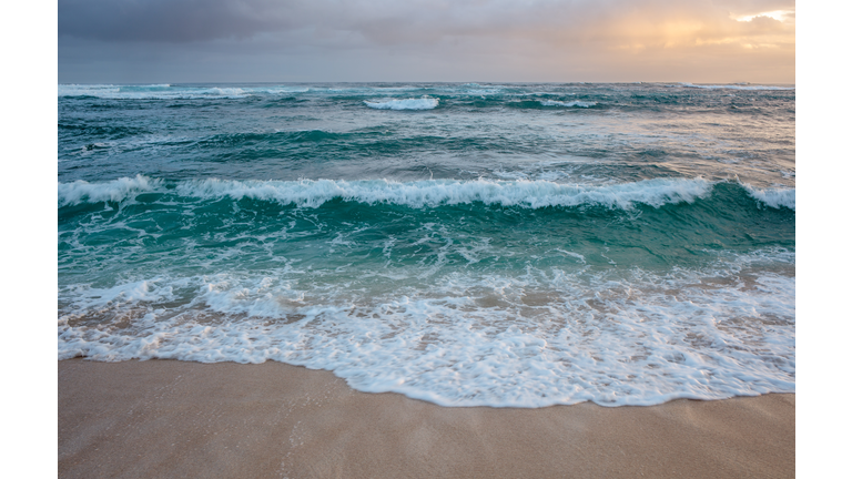 rolling ocean waves at dusk