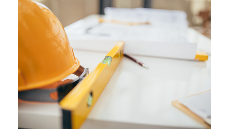 Table with hard-hat and blueprints