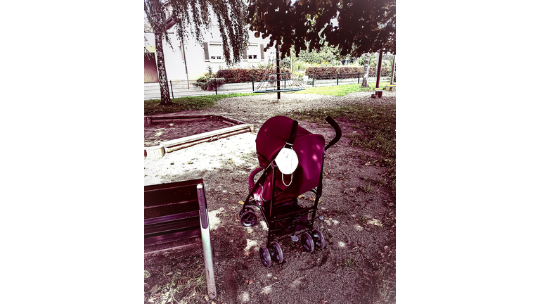 Stroller with mask stands in lockdown alone on the playground