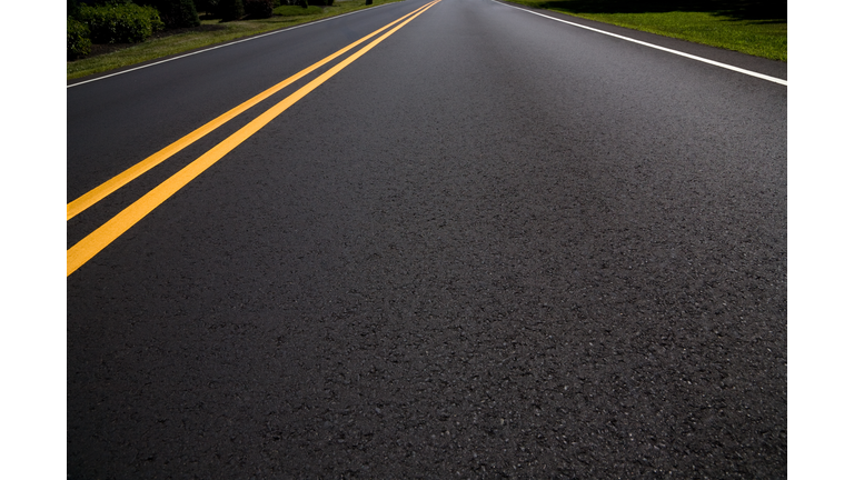 Right Lane of a Freshly Paved Asphalt Road Diminishing Perspective