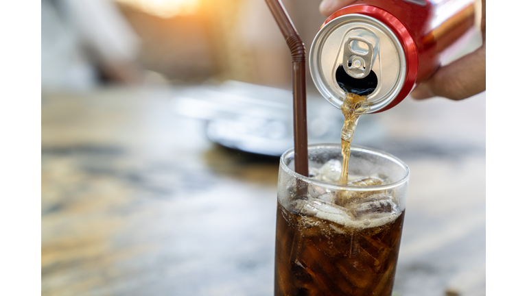 Filling soft drink into a glass.