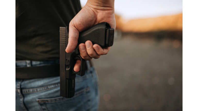 Man with a gun, close-up, copy space.