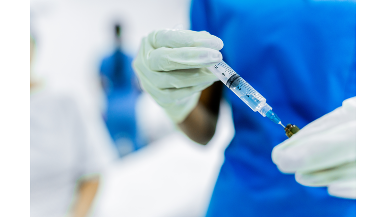 Close-up of a female nurse preparing vaccine at the hospital