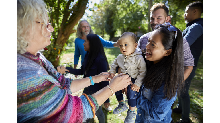 People with baby on a garden party