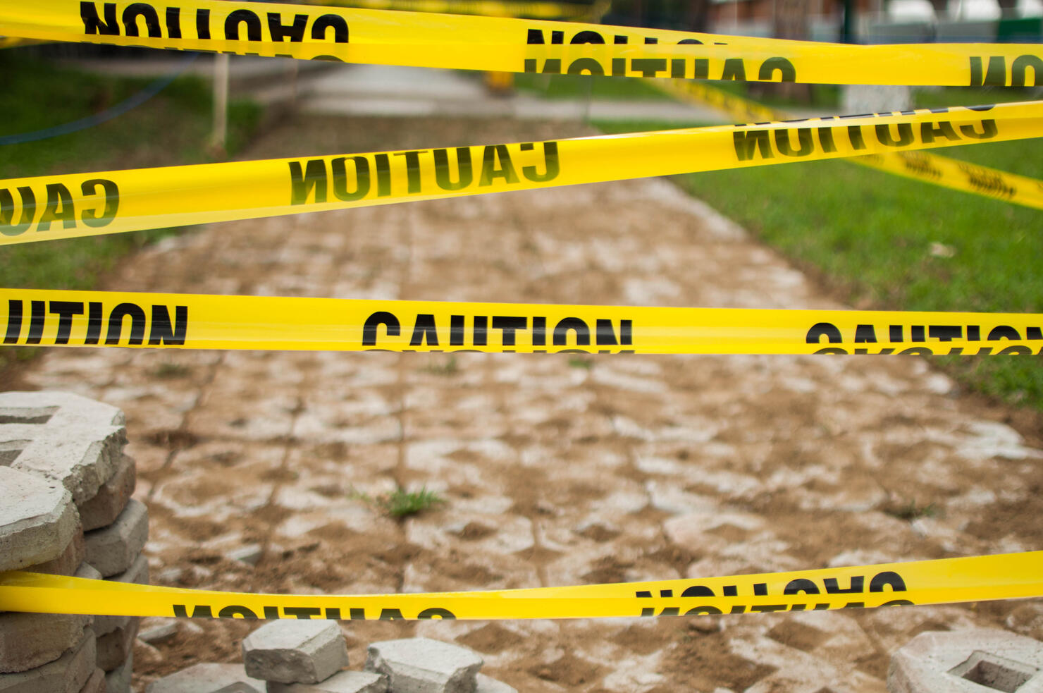Yellow tape caution sign outdoor during day time