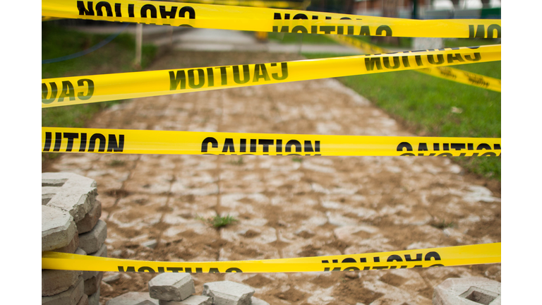Yellow tape caution sign outdoor during day time