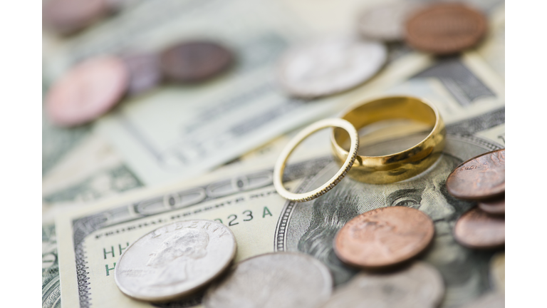 Close up of wedding rings with money