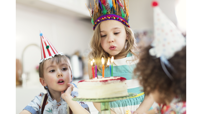 Girl blowing out birthday candles