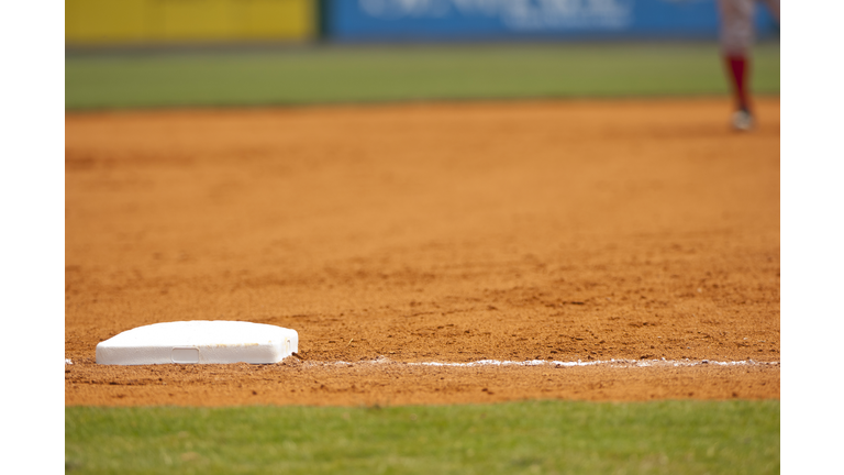 Baseball Player Running to third base on Baseball Field during Baseball Game