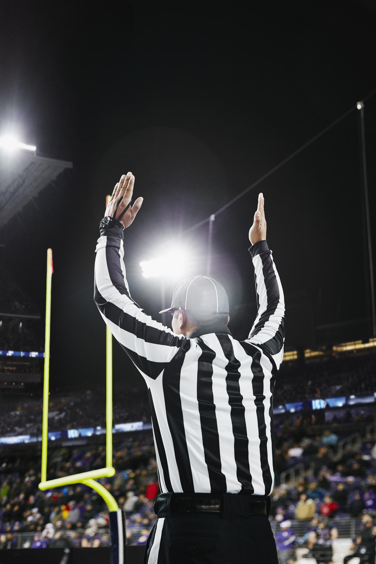 Referee signaling touchdown on field during game