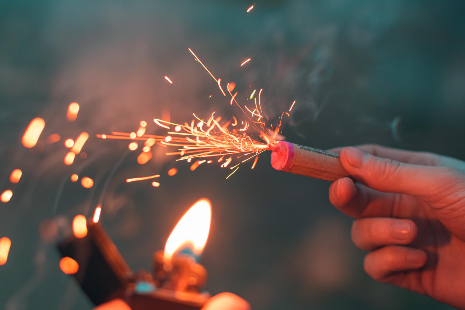 Young Man Lighting Up Firecracker in his Hand