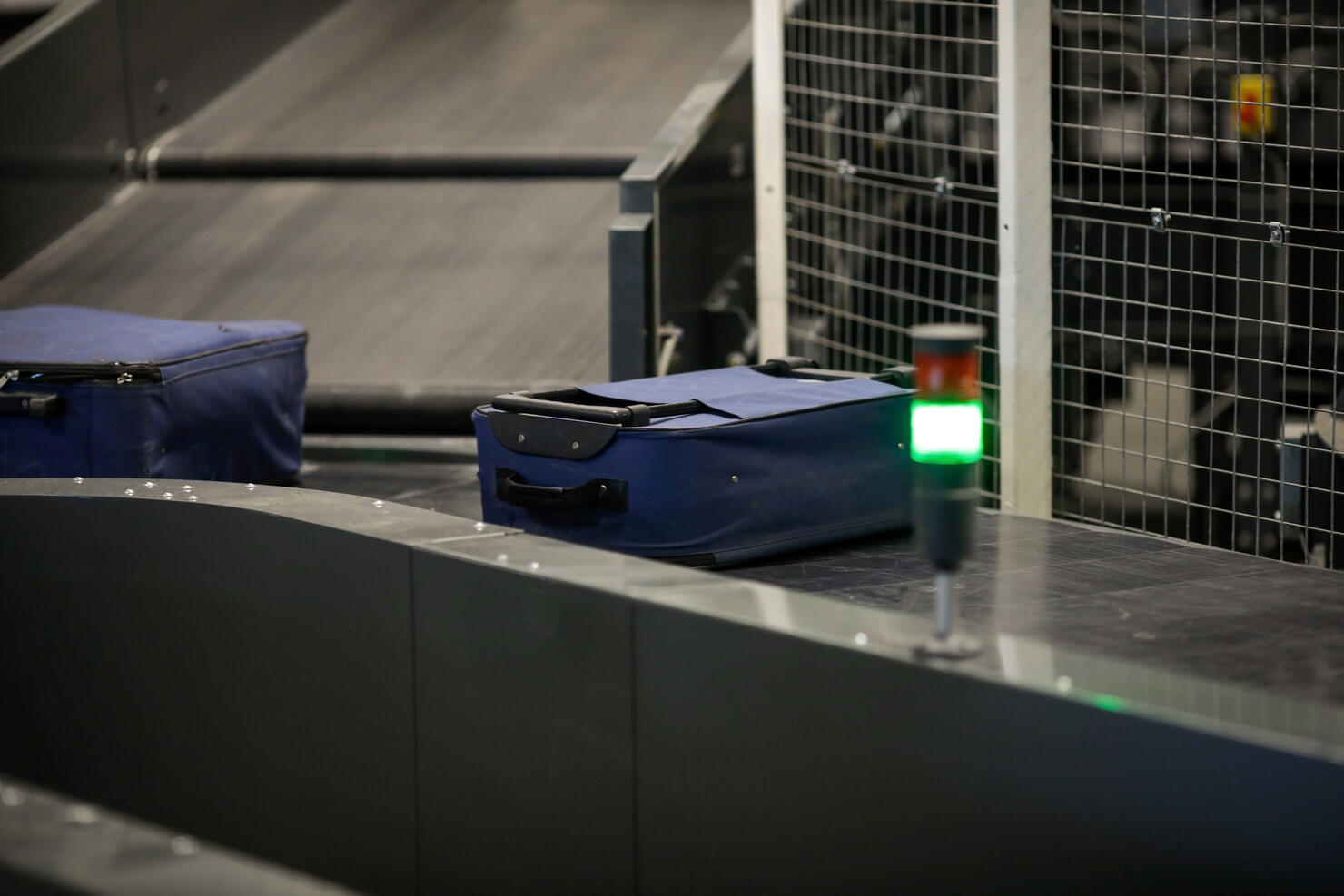 Baggage on a conveyor belt inside a luggage sorting system at an airport