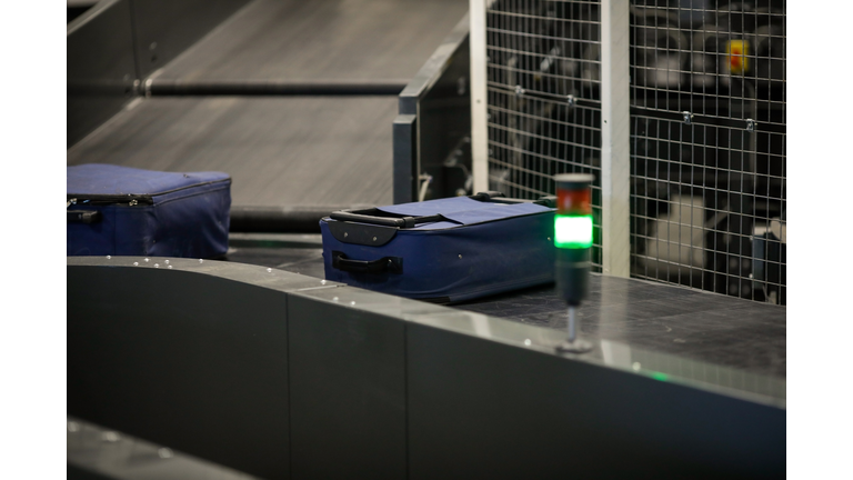 Baggage on a conveyor belt inside a luggage sorting system at an airport