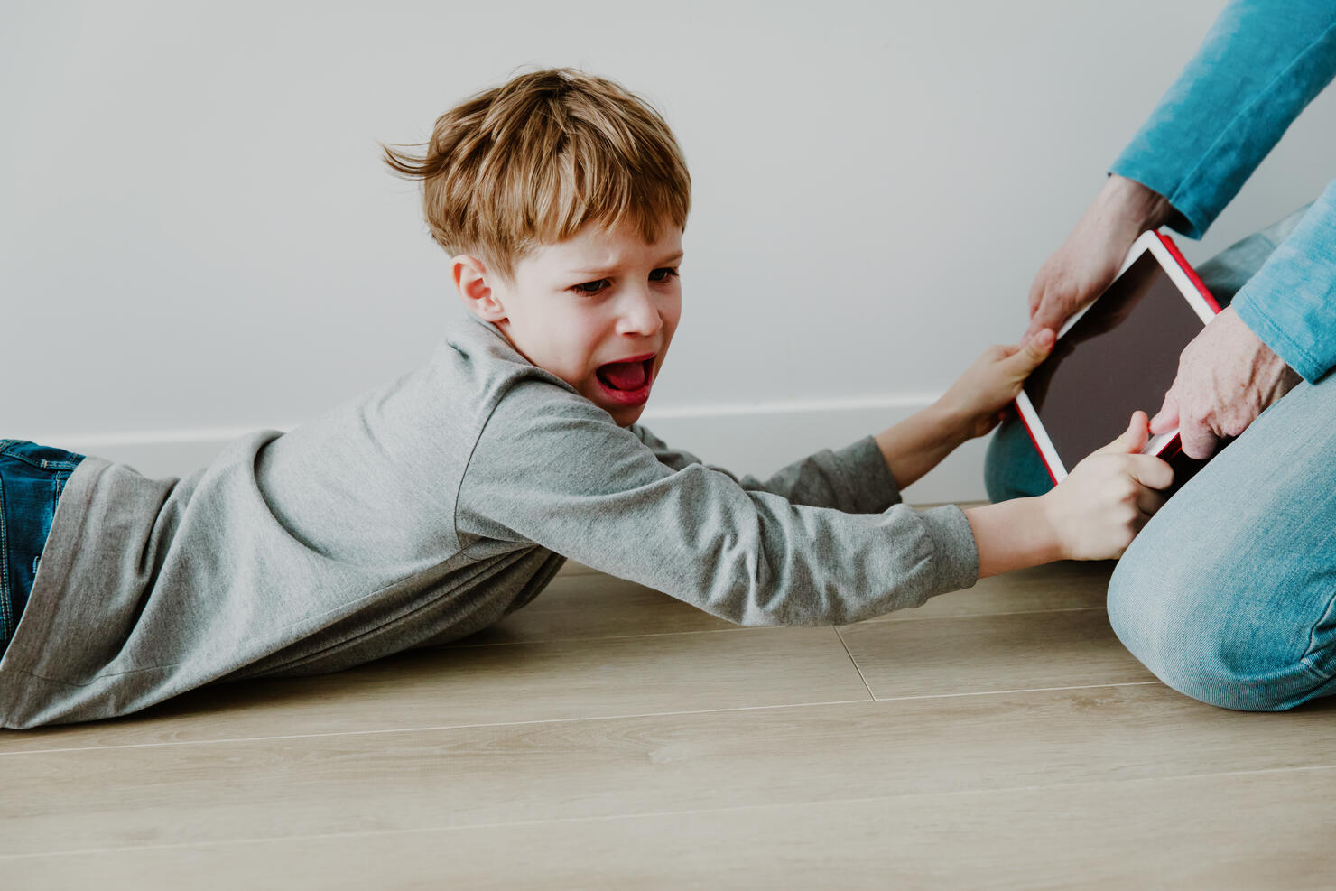 computer addiction- father taking touch pad from angry child