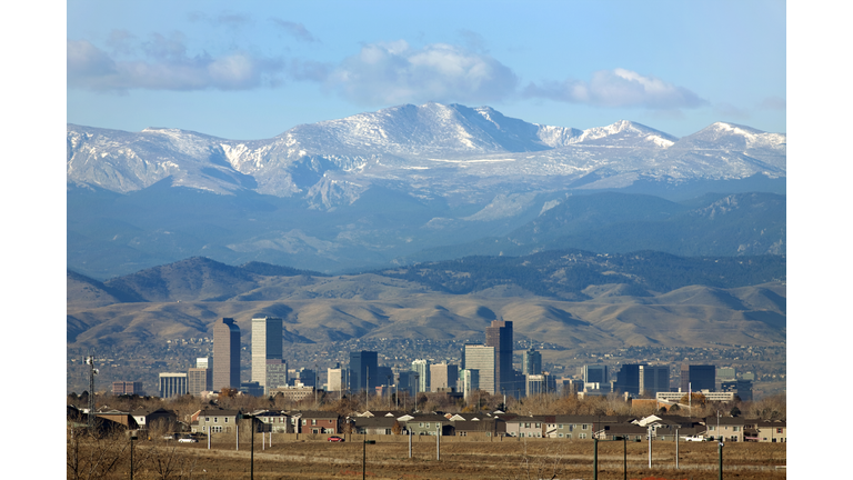 Rocky Mountains Front Range homes and downtown Denver Colorado skyscrapers