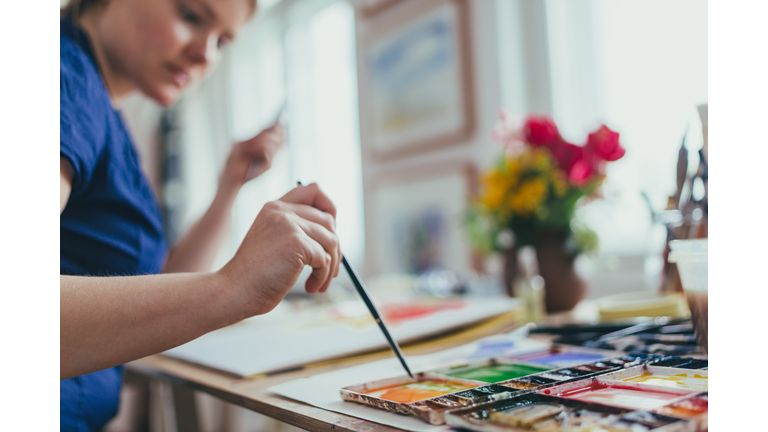 Woman painting watercolour.