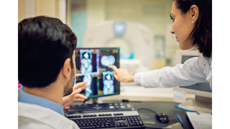 Doctors are working with CT scan in hospital