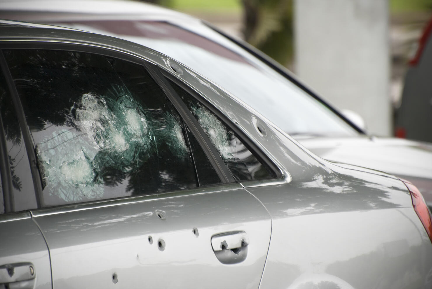 Armoured car with bullet holes, crime and terrorism concept