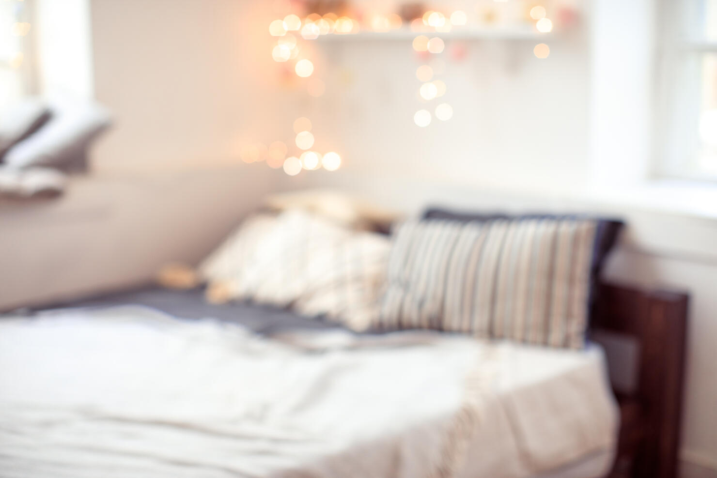 blurred bedroom background with bed window and lights