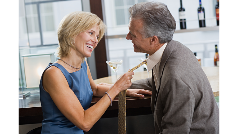 Woman pulling man's tie